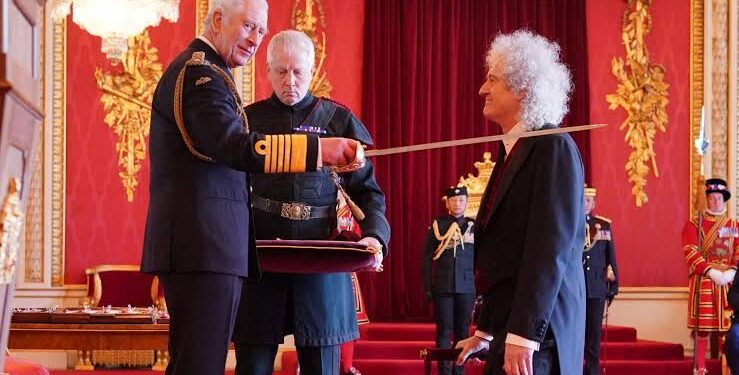 Knighted by Queen, Brian May makes light of the fact that his knees “just about” held…