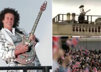 Brian May, a guitarist, performs the National Anthem from…